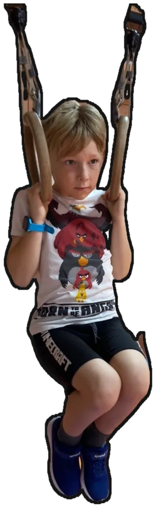 Kluk visí na kruzích s koleny přitaženými k hrudi